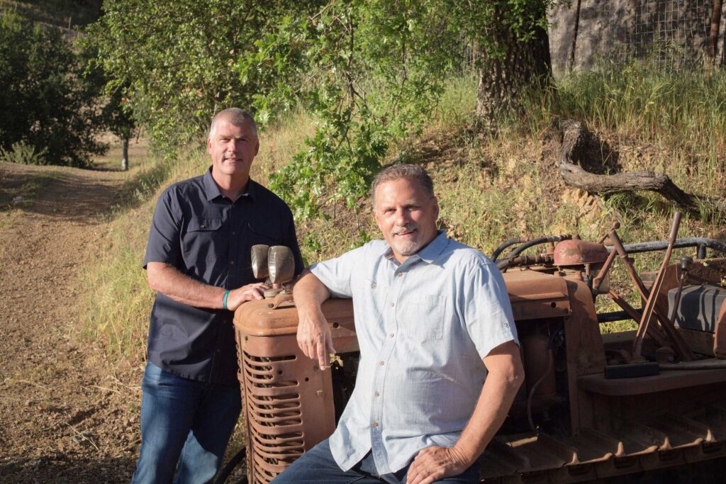 David (standing) and Ernie (seated on a vintage tractor) Ilsley